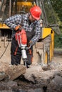 A laborer uses a jackhammer to break up a concrete pavement Royalty Free Stock Photo