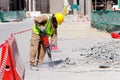 A laborer uses a jackhammer to break up a concrete pavement Royalty Free Stock Photo