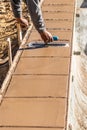 Laborer Using Trowel On Wet Cement Forming Coping Around New Pool Royalty Free Stock Photo