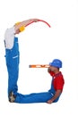 Laborers forming a G letter Royalty Free Stock Photo