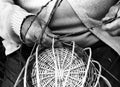 Laborious hands of elder craftsmen create a wicker basket