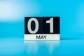 Labour day - May 1st. Day 1 of month, calendar on blue background. Spring time Royalty Free Stock Photo