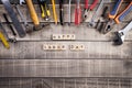 Labour Day, Wooden Block calendar with many handy tools on wooden background texture