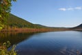 Blue colored Labrador Pond in Truxton during early Fall seasonal colors