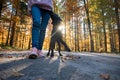 Labrador retriever puppy walking heel with her female owner