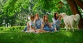 Labrador walking around family on picnic. Joyful dog play with people on nature. Royalty Free Stock Photo