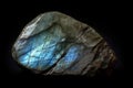 Labradorite is a rare precious natural stone on a black background. AI generated. Header banner mockup with space. Royalty Free Stock Photo