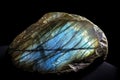 Labradorite is a rare precious natural stone on a black background. AI generated. Header banner mockup with space. Royalty Free Stock Photo