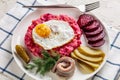 Labskaus, mashed potatoes with the beet, fried egg Royalty Free Stock Photo