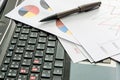 Labtop , financial charts , Document file , pen on the table Royalty Free Stock Photo