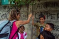 LABUAN BAJO, INDONESIA - Dec 11, 2014: Indonesian children with a Caucasian tourist portrait`on the street