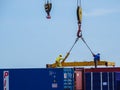 Labuan,Malaysia-Feb 26,2020:Busy crane & foreman workers unloading containers box from cargo freight ship at the port of Labuan is