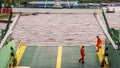 Labuan,Malaysia-July 29,2019:Crew worker in orange coveralls & wearing protective equipment helmet standing on edge of deck while