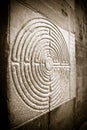 Labyrinth carved on the facade of a Romanesque church of the 11th century (Tuscany - Italy)