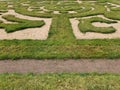 Labyrinth of green grass and sand in the garden.