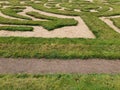 Labyrinth of green grass and sand in the garden.