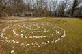 Labyrinth made of white stones on a green meadow near Beli on a sunny day in spring