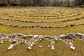 Labyrinth made of white stones on a green meadow near Beli on a sunny day in spring