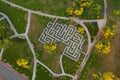 A labyrinth in a summer green landscape park in Kiev. A maze of hedges surrounded by paths, trees and bushes. Drone view Royalty Free Stock Photo
