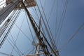 Labyrinth of tall ship rigging lines and masts seen from below, against a deep blue sky Royalty Free Stock Photo