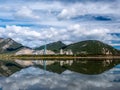 Lac Des Arcs, Alberta, Canada with a beautiful relfection and a cement plant in the background Royalty Free Stock Photo