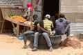 Unidentified Senegalese boys sit on the car wheels.