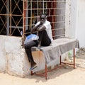 Unidentified Senegalese man sits on the massage table.