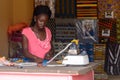 Unidentified Senegalese woman sews some clothes.