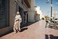 LAC ROSE, SENEGAL - JANUARY 18, 2020: Women walking down the street, wearing beautiful blue and white Arab clothes.