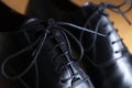 Lace close-up detail of a pair of classic black leather shoes Royalty Free Stock Photo