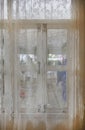 The lace curtain at a glass window Royalty Free Stock Photo