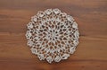 Lace doily on dark wood