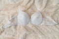 Lace female bra on beige cloth, closeup Royalty Free Stock Photo