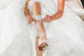 Lace garter and blue bow that the bride wears on her leg while getting dressed on her wedding day. Royalty Free Stock Photo