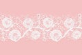 Lace horizontal seamless openwork roses. White lacy mesh on a pink background.