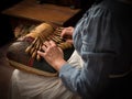 Lace maker with antique pillow and bobbins Royalty Free Stock Photo