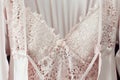 Lace nightgown and cream silk robe on pink background