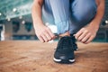 Lace shoes, fitness and woman on ground for workout, running and wellness. Closeup female tie sneakers for exercise