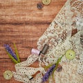 Lace and thread on wooden background Royalty Free Stock Photo