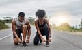 Lace up and let the race begin. a sporty young couple tying their shoelaces while exercising outdoors. Royalty Free Stock Photo