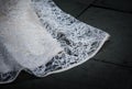 Lace wedding dress train flows to the ground Royalty Free Stock Photo