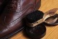 Laced brown leather classic Brogue shoes with polishing cream and brush