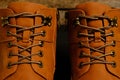 Laced brown winter boots.Background men`s and women `s shoes