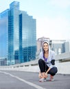 Laced up, playlist queued - ready to run. Portrait of a young female jogger tying up her shoes before a run through the Royalty Free Stock Photo