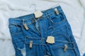 Lacerate blue jean with two clothes hanger Royalty Free Stock Photo