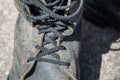 Laces on Dirty black leather boots from the army. Closeup view Royalty Free Stock Photo