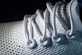 Laces and eyelets of running shoe, close up. on black background.