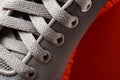 Lacing of gray textile sport shoes close-up