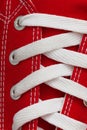 Lacing on a retro sneaker, close-up, on a blue wooden background