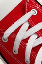 Lacing on a retro sneaker, close-up, on a blue wooden background